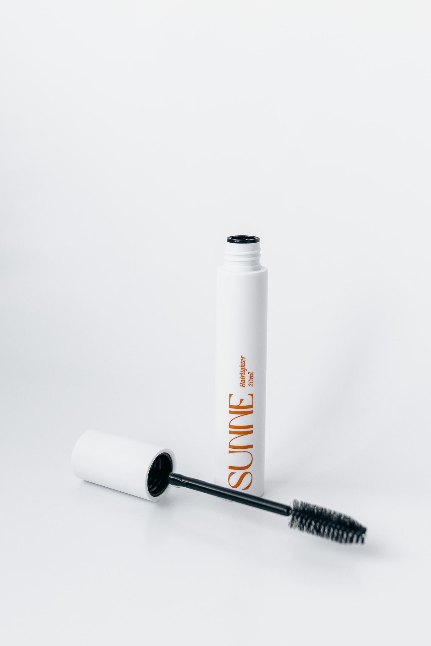 The Sunne Hairlighter tube with the wand applicator open, designed for precise and effortless at-home hair lightening.
